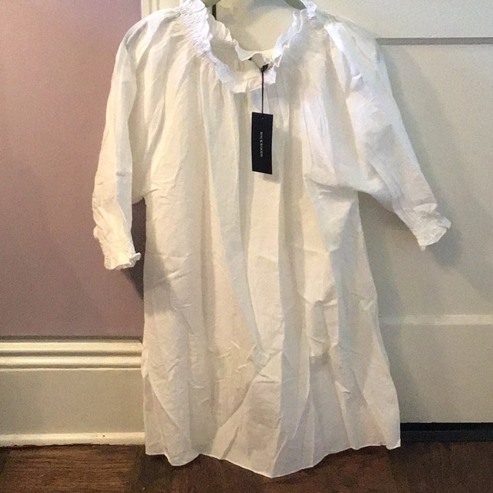 White long smocked top. Ruffle neck.